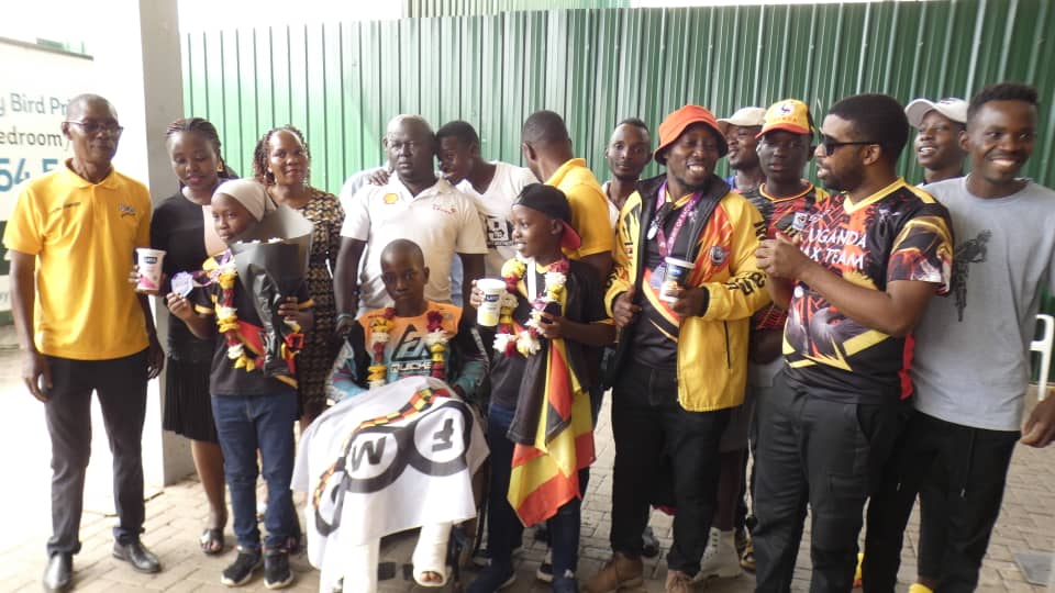 Ugandan riders get heroic welcome home.